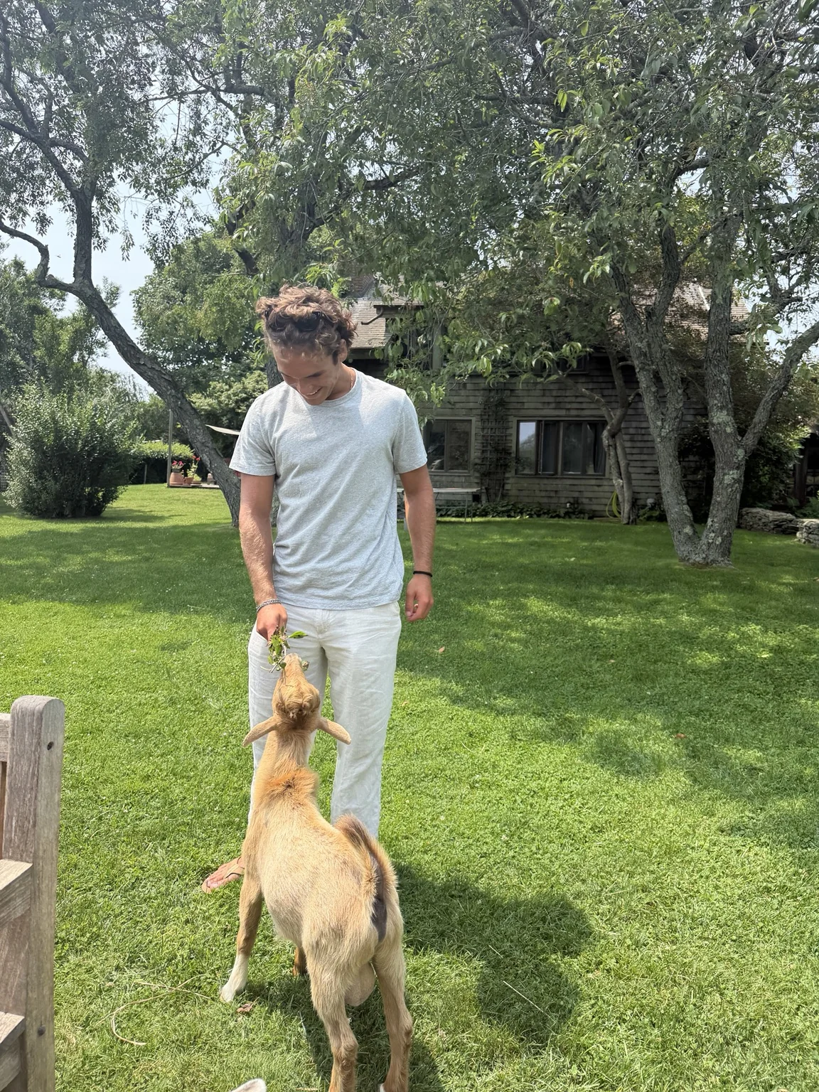 TJ outdoors with a goat